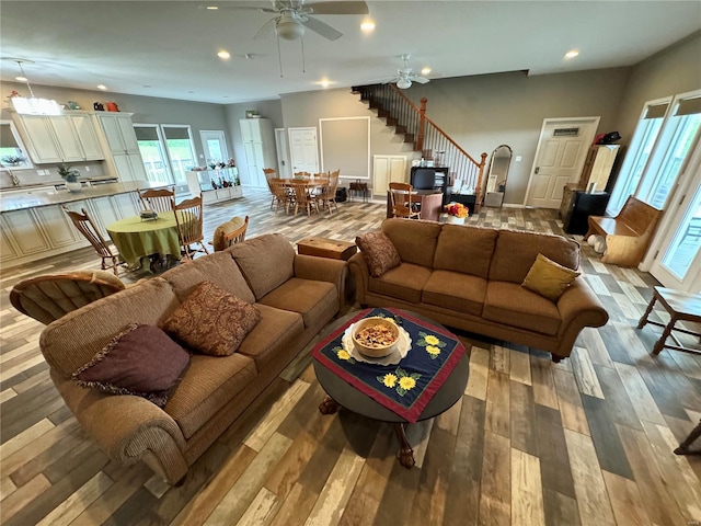 living room featuring ceiling fan and light wood-type flooring