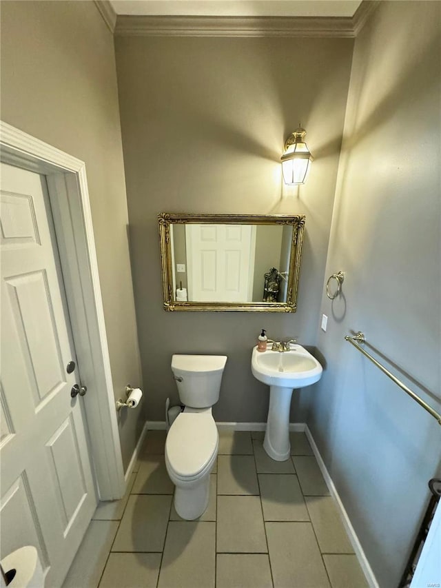 bathroom with crown molding, tile patterned flooring, and toilet