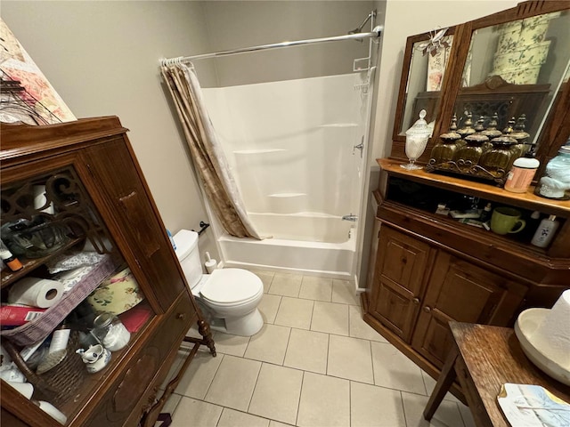 bathroom with tile patterned floors, toilet, and shower / bath combo with shower curtain