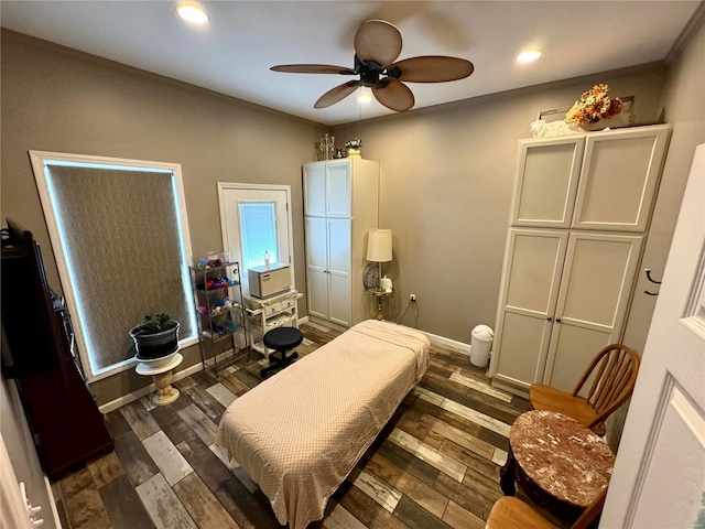 bedroom featuring ceiling fan, dark hardwood / wood-style flooring, and crown molding