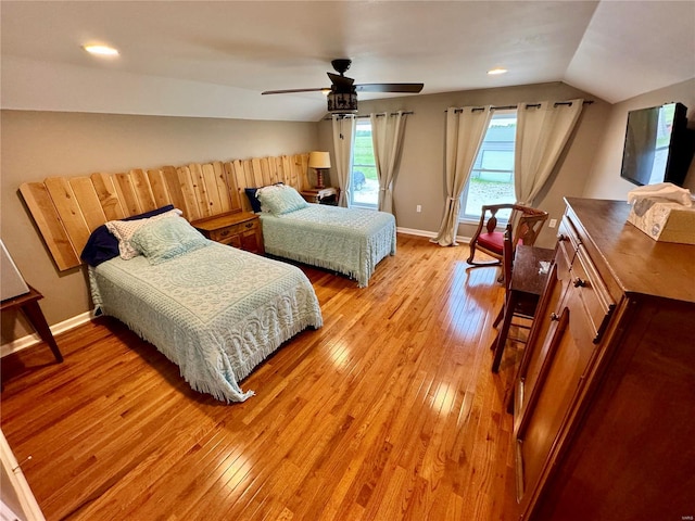 bedroom featuring ceiling fan, light hardwood / wood-style floors, and lofted ceiling