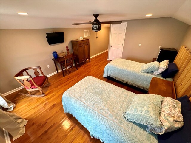 bedroom featuring hardwood / wood-style floors, ceiling fan, and lofted ceiling