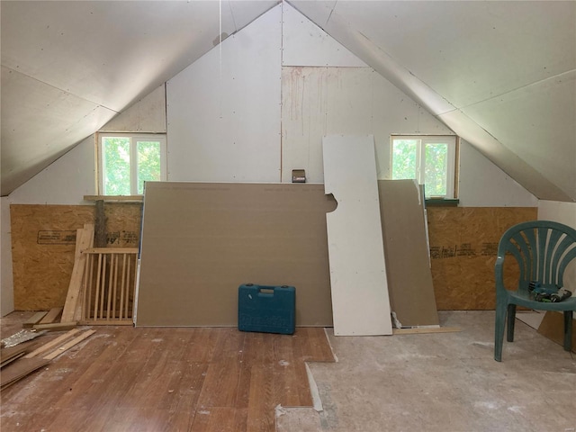 additional living space with vaulted ceiling and wood-type flooring