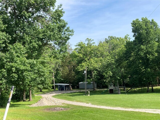 view of home's community with a yard