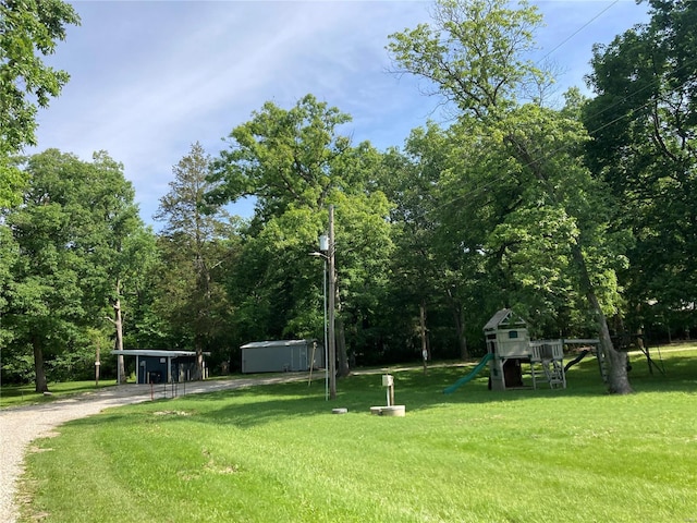 view of yard with a playground and a carport