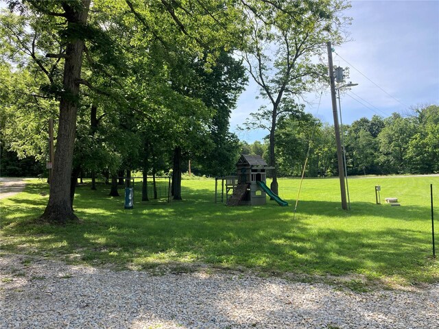 view of property's community featuring a playground and a yard