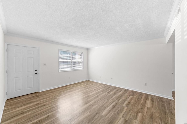 interior space with crown molding, wood-type flooring, and a textured ceiling