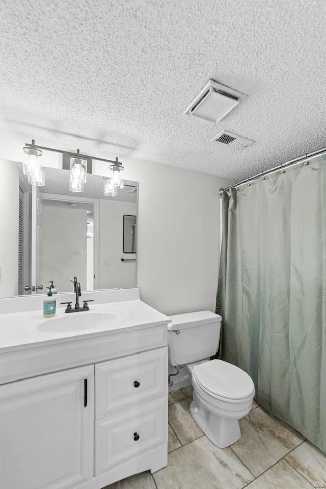 bathroom featuring vanity, curtained shower, toilet, and a textured ceiling