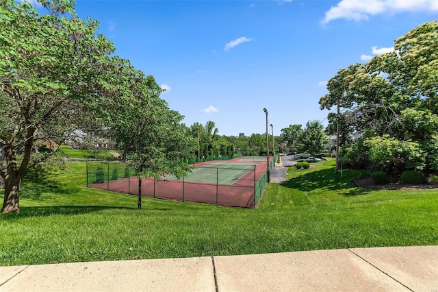 view of sport court with a yard