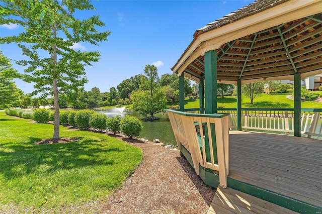 view of yard with a deck with water view and a gazebo