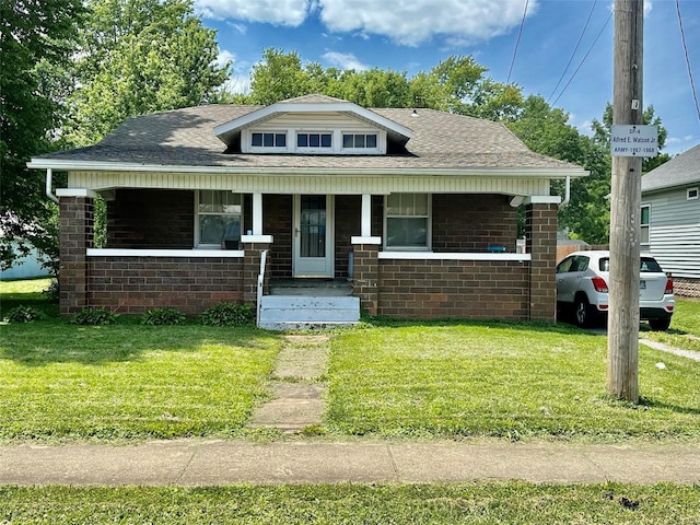 bungalow with a front yard and covered porch