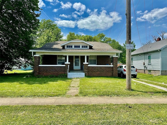 bungalow-style house with covered porch and a front lawn