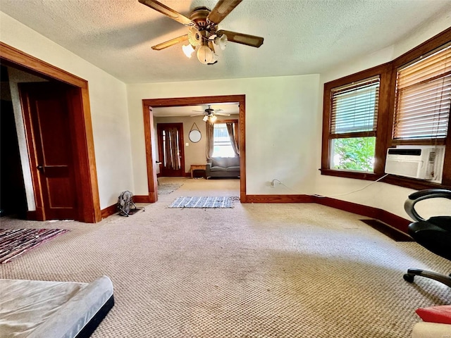 interior space featuring carpet, ceiling fan, and a textured ceiling