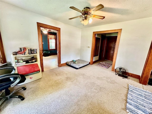 interior space featuring ceiling fan and a textured ceiling