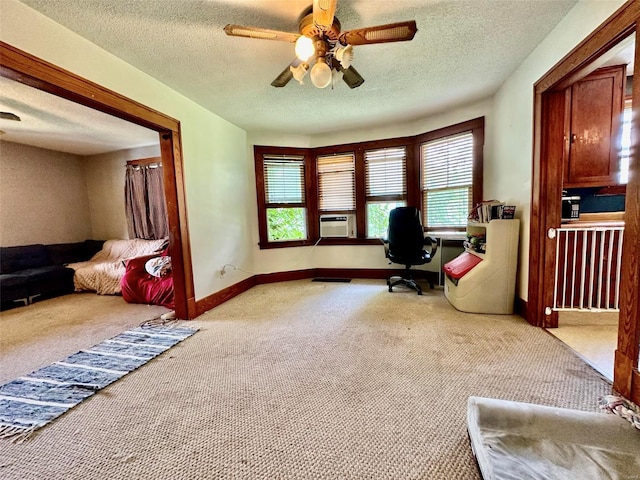 office space with light carpet, a wealth of natural light, and a textured ceiling