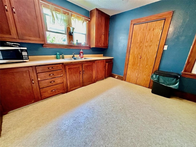 kitchen with sink and a textured ceiling