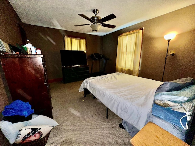 bedroom with ceiling fan, a textured ceiling, and carpet flooring