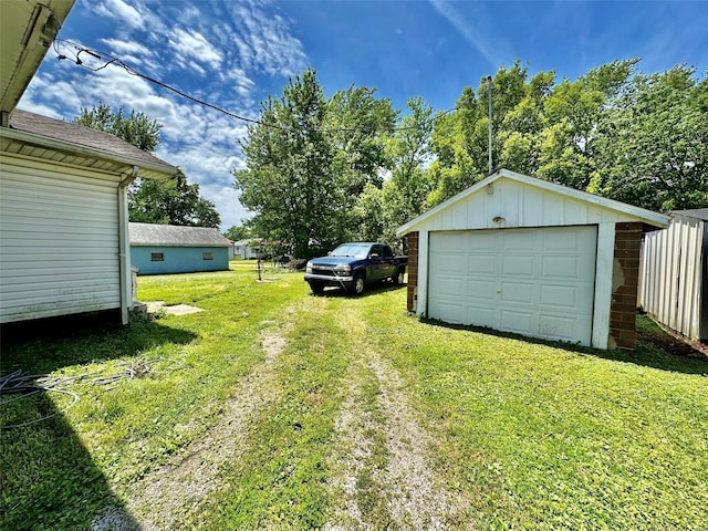 view of yard featuring an outbuilding and a garage