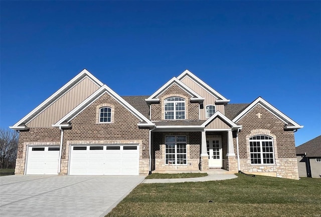 craftsman house with a front yard and a garage