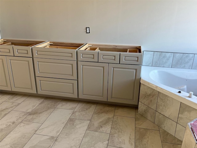 bathroom featuring tiled tub