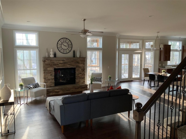 living room featuring crown molding, a fireplace, ceiling fan, and hardwood / wood-style flooring