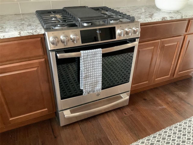 kitchen featuring dark hardwood / wood-style flooring and range with two ovens