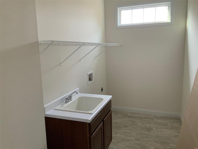 laundry room with electric dryer hookup, cabinets, sink, and hookup for a washing machine