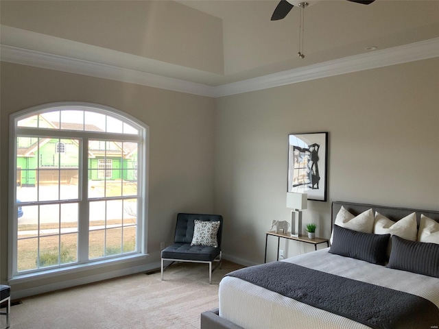 bedroom featuring multiple windows, carpet flooring, ceiling fan, and ornamental molding