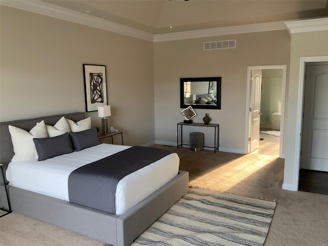 bedroom featuring connected bathroom, carpet floors, and crown molding