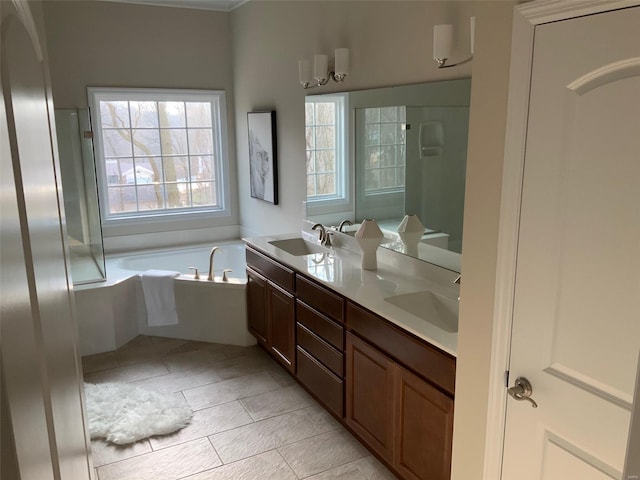 bathroom with a bathtub, vanity, and tile patterned flooring