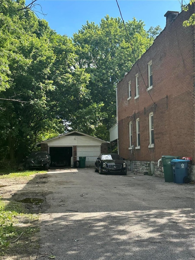 view of side of property featuring a garage and an outdoor structure