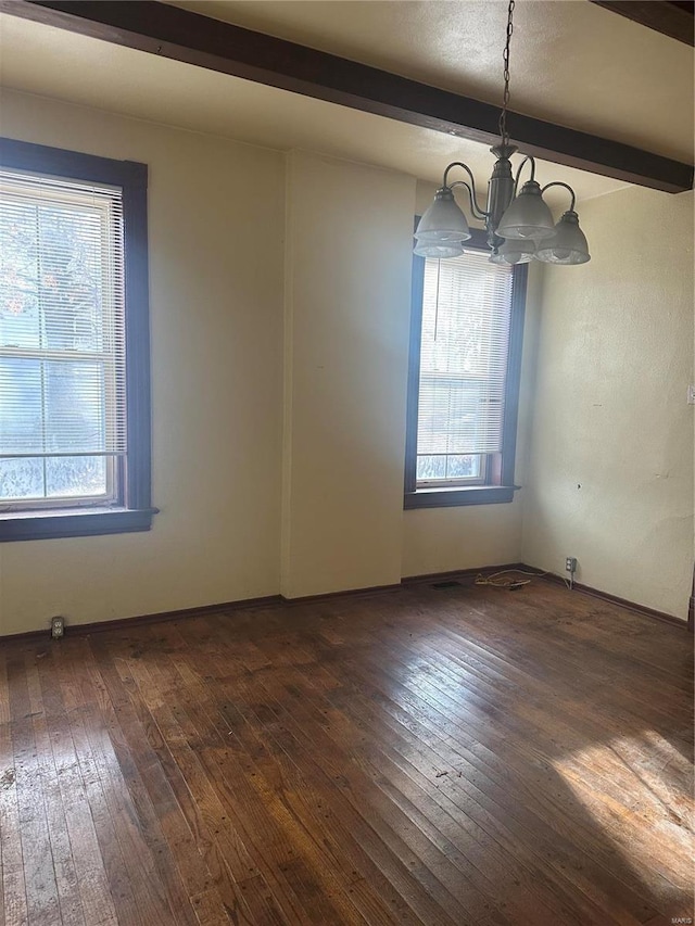 spare room featuring beamed ceiling, a notable chandelier, and dark wood-type flooring