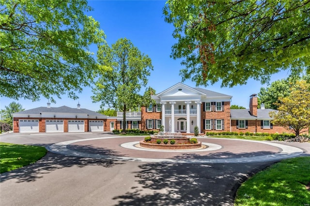 greek revival inspired property with a garage