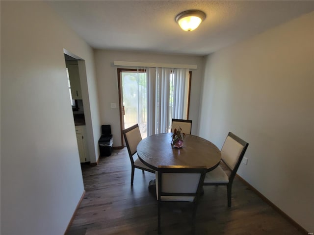 dining space with dark hardwood / wood-style floors