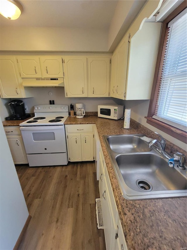 kitchen with white appliances, sink, white cabinets, and dark wood-type flooring