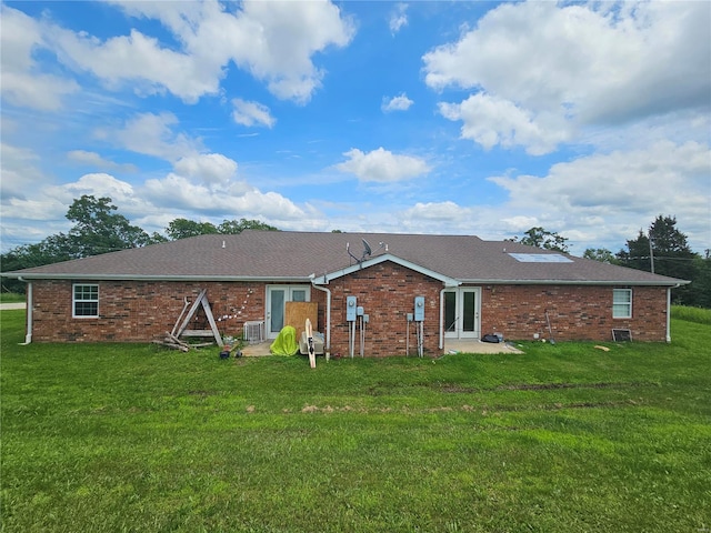 rear view of property featuring a yard