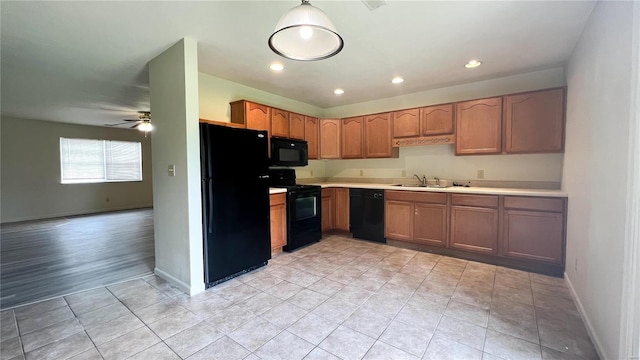 kitchen featuring ceiling fan, black appliances, sink, and light hardwood / wood-style flooring