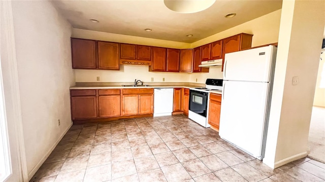 kitchen with white appliances, sink, and light tile floors