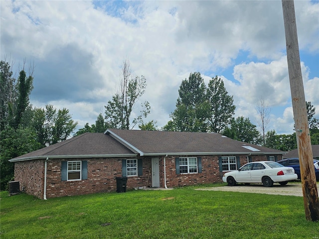 single story home featuring a front yard and central air condition unit