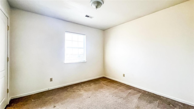 unfurnished room featuring carpet