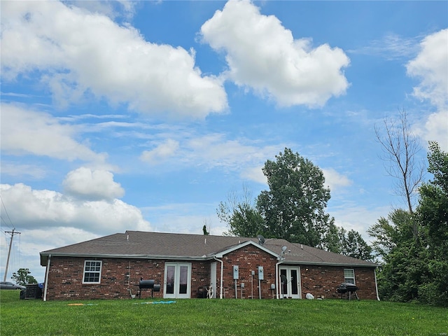 view of front of property with french doors and a front lawn