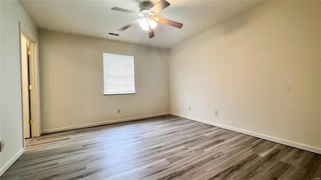 empty room featuring ceiling fan and hardwood / wood-style flooring