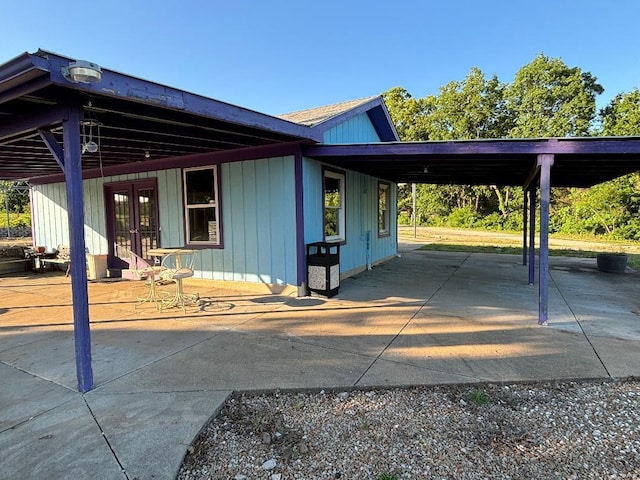 view of side of home with french doors and an attached carport