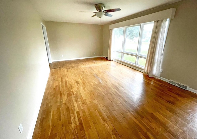 spare room featuring ceiling fan and light hardwood / wood-style flooring