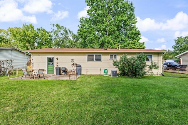 rear view of house featuring a patio area, a yard, and central AC unit