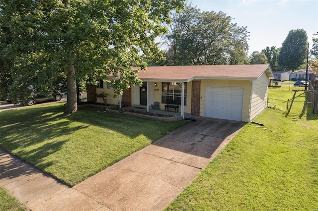 view of front of home featuring a front yard, a garage, and covered porch