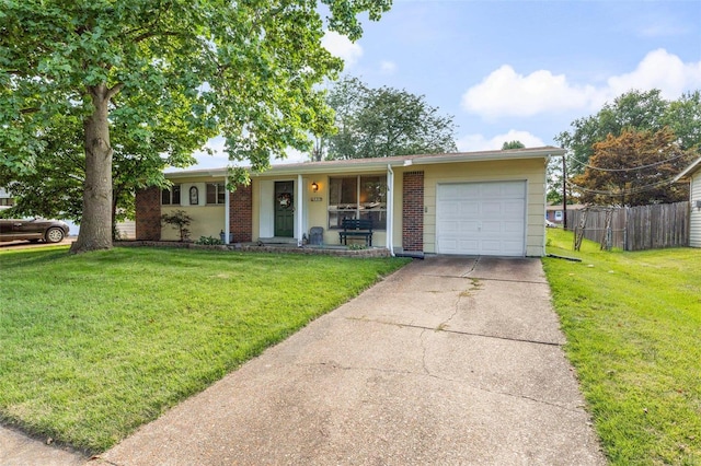 single story home featuring a porch, a garage, and a front lawn