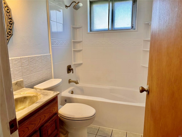 full bathroom with vanity, tiled shower / bath, tile patterned flooring, toilet, and tile walls