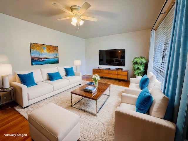 living room featuring ceiling fan and wood-type flooring