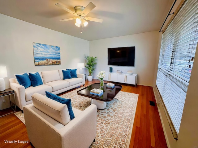 living room with hardwood / wood-style floors and ceiling fan